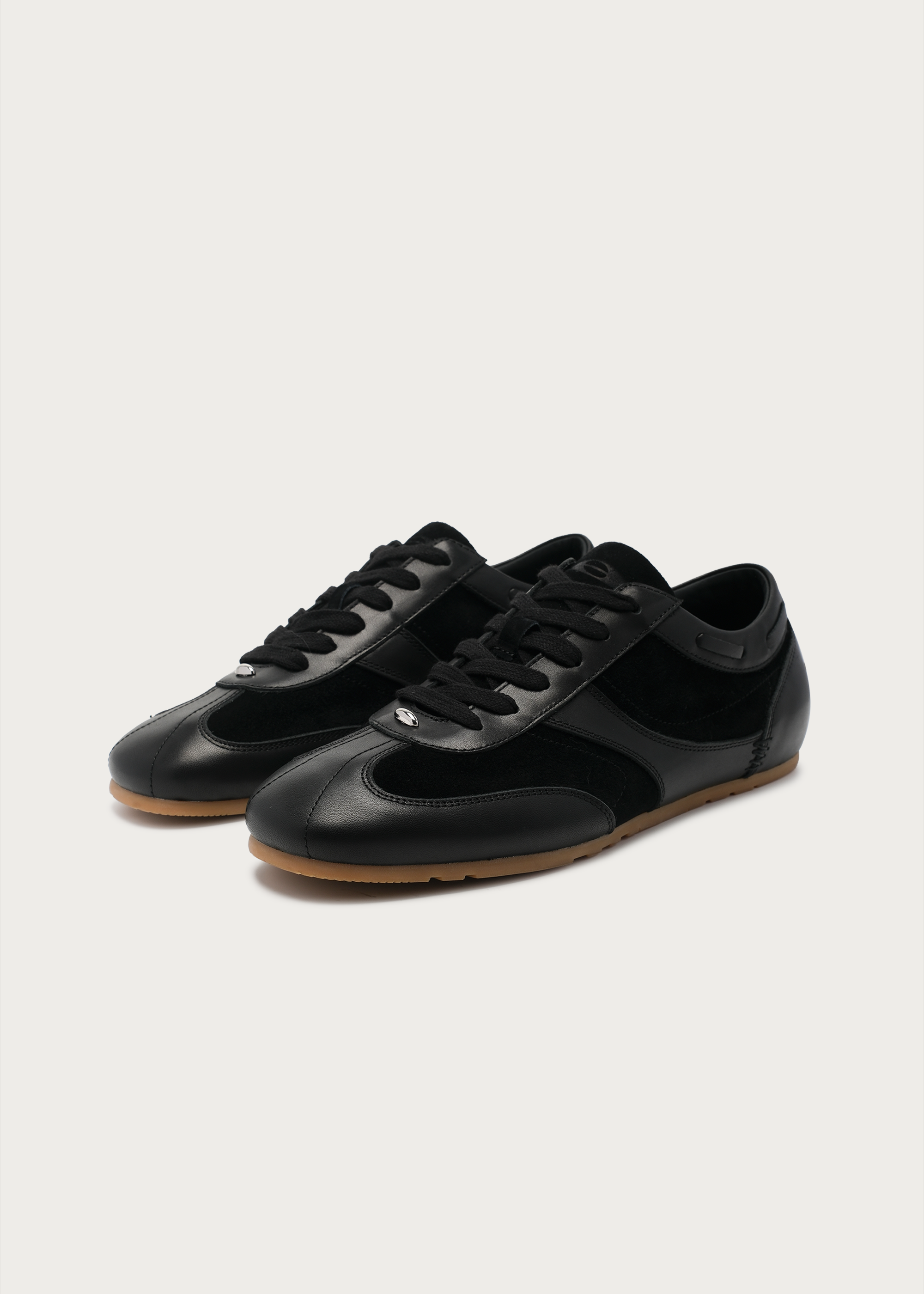 Black metal-embellished leather sneakers front view