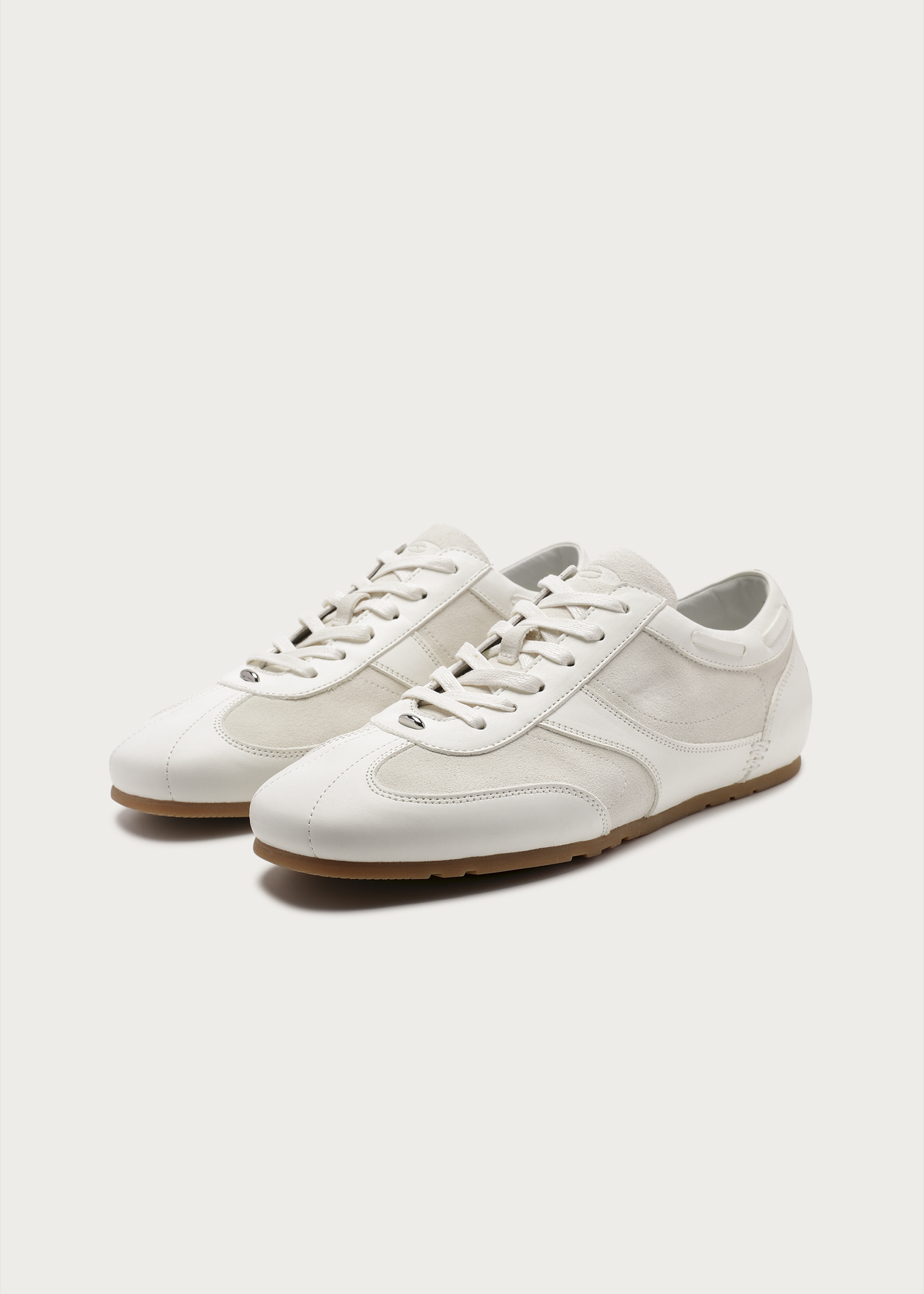 White metal-embellished leather sneakers front view